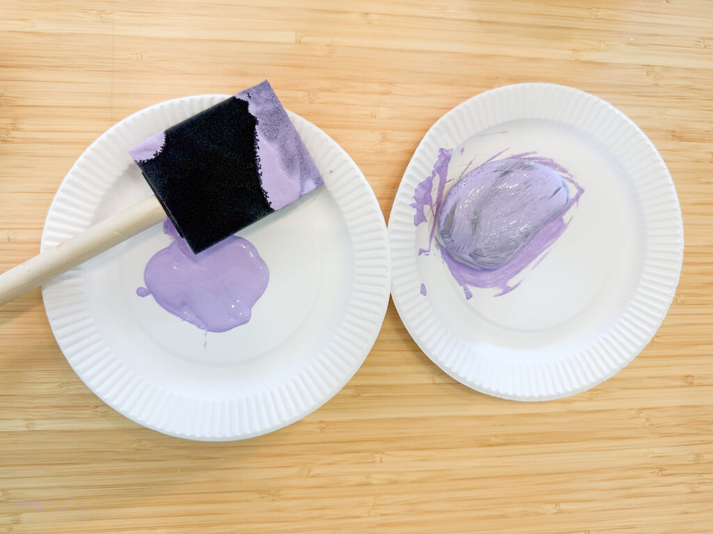 Picture of the rock being painted by the paint brush.